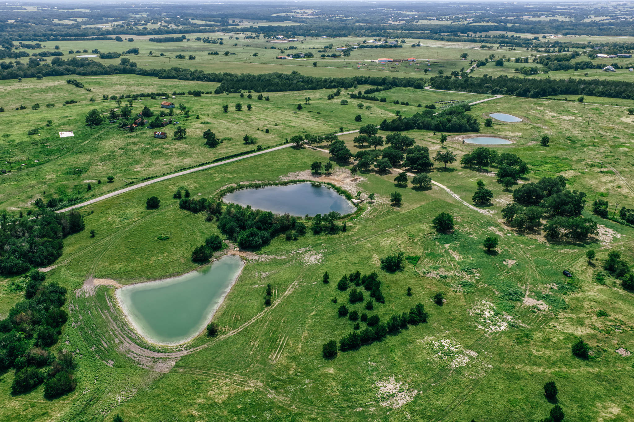 Wide property aerial, two ponds and tree lines — Lot 4